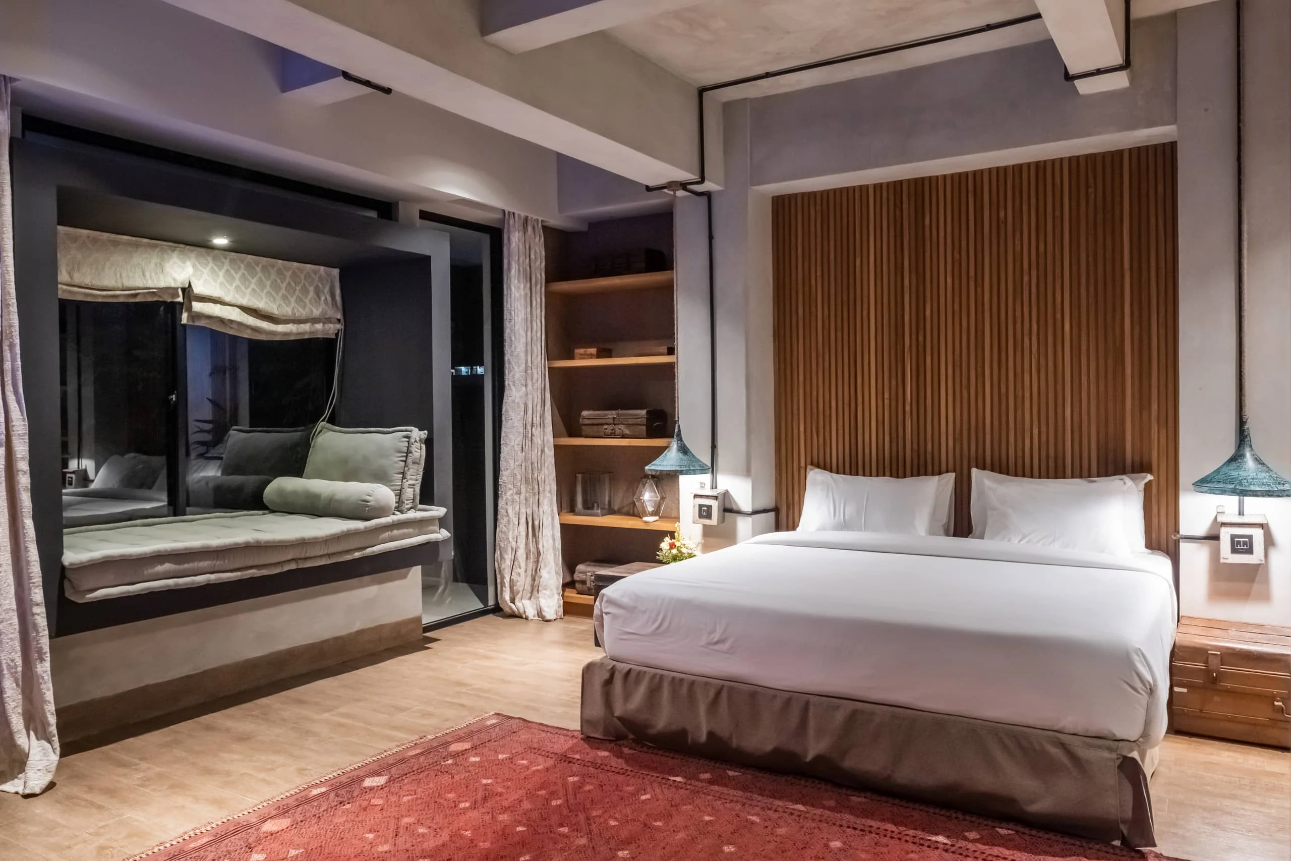 Private bedroom with warm timber and a garden-facing window seat