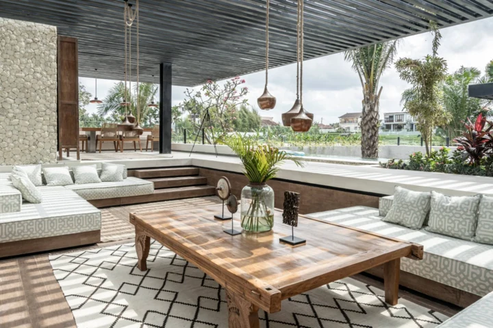 Covered outdoor lounge overlooking tropical greenery